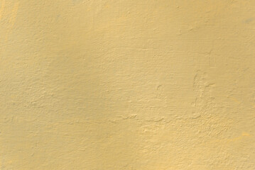 Photo of an old concrete wall tinted yellow to use as a background
