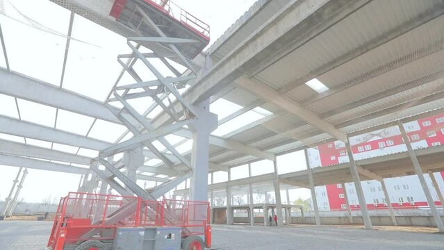 Mobile lifting platform at the construction site. Professional construction equipment. Large folding lifting platform.