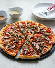 Homemade vegetarian pizza on a plate.
