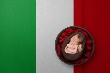 Newborn portrait on background in color of national flag. Patriotic photography concept. Italy