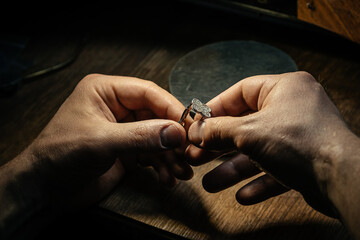 Different goldsmiths tools on the jewelry workplace. Jeweler at work in jewelry. Desktop for craft...