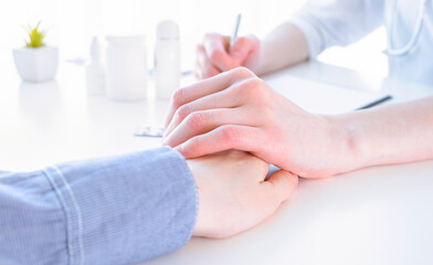 Doctor advising patient in hospital office