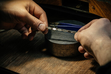 Different goldsmiths tools on the jewelry workplace. Jeweler at work in jewelry. Desktop for craft...
