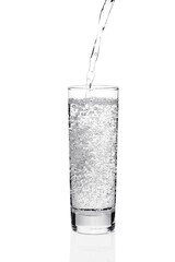 Pouring water into glass with bubbles
