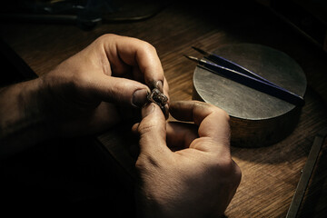 Different goldsmiths tools on the jewelry workplace. Jeweler at work in jewelry. Desktop for craft...