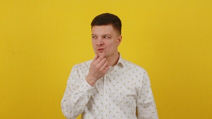 A cunning young guy in a shirt is plotting or inventing something. I got an idea