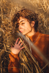 Portrait of beautiful young woman outdoor posing and looks thoughtfully into the distance