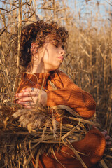 Profile of beautiful young woman outdoor posing, beautiful side view of her face