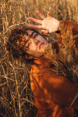 Portrait of beautiful young woman while posing with her arm over her heads