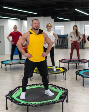 Women's and men's group on a sports trampoline, fitness training, healthy life - a concept trampoline group batut girl healthy, for female athletic for fitness for exercise person, shape sportswear