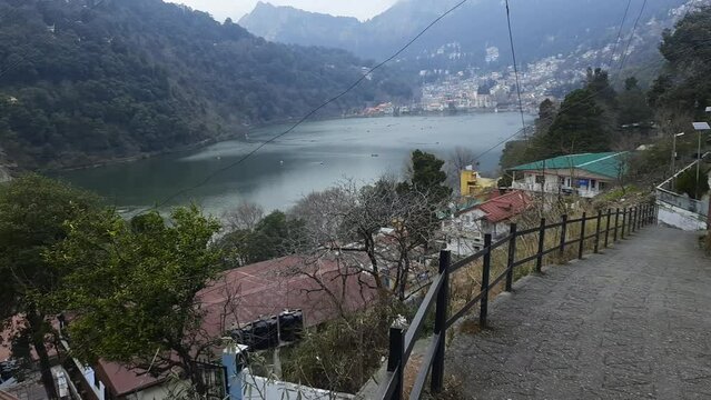 Full view of Naini Lake during evening time near Mall Road in Nanital, Uttarakhand, India, Beautiful view of mountains and blue sky at Nainital Lake side