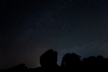 Fototapeta na wymiar Night landscape with Perseid meteor in Barruecos. Spain.