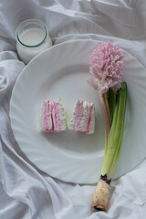 sweet marshmallow and hyacinth on a plate with a glass of milk