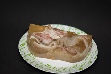 Pieces of pork prepared in Bistrita, Romania, Piftie, cold, drum -Sliced pork meat products, traditional romanian food at winter Christmas market, Sausages and cold cuts