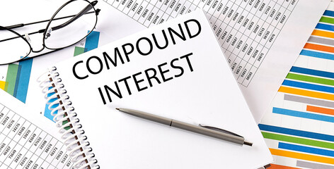 Notebook with text COMPOUND INTEREST . Diagram and white background,Business concept