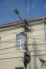 Electric cables telephone boxes and video cameras and on a pole, in Cluj, Romania, 2022