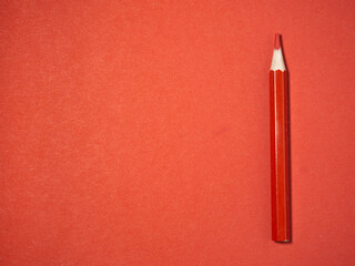  red wooden pencil on  red paper. Sharpened pencils. Drawing tool.  Accessories for creativity.