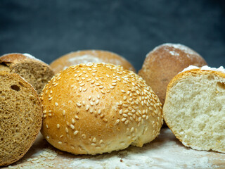 Bakery products.  Buns on a cutting board. Rye and wheat buns. Products from premium wheat flour and rye flour.