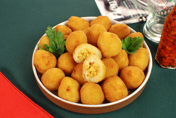 Traditional Brazilian fried snack made with chicken called Coxinha with one cut