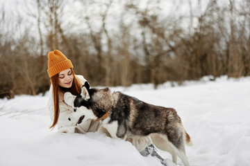 woman in the snow playing with a dog fun friendship Lifestyle