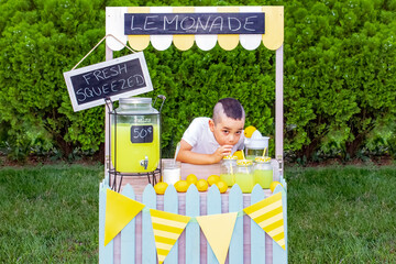 Boy drinking the lemonade he is selling