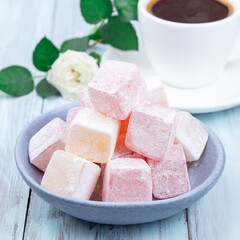 Turkish delight or lokum confection rose and lemon flavored with cup of coffee and rose, square