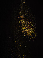 Golden stream of oriental spices on a black background. Levitation. Cooking, oriental cuisine. Seasonings, spices. Recipe book, food blog, restaurant, hotel, cafe, banner, advertisement. - obrazy, fototapety, plakaty