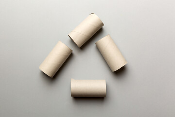 Empty toilet paper roll on colored background. Recyclable paper tube with metal plug end made of kraft paper or cardboard