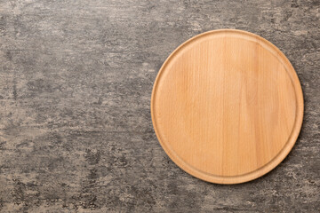 Top view of wooden cutting board on cement background. Empty space for your design