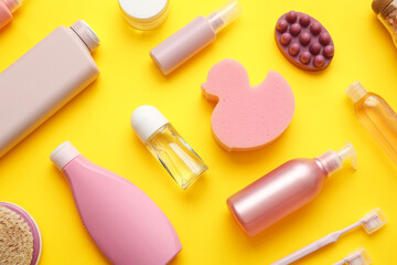 Composition with different cosmetic products and bath supplies on yellow background