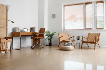 Interior of light room with modern workplace and comfortable armchairs