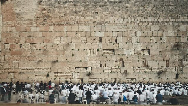 Crowd of Jewish people praying at the holy western wall in Old Jerusalem. Time lapse. 
