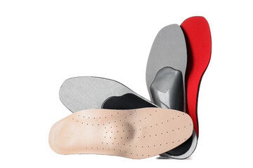 Different orthopedic insoles on white background