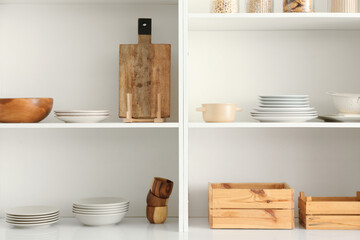 Shelf unit with clean dishware in kitchen