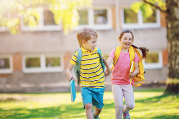 Boy and girl running to the school
