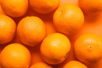 Many ripe oranges on color background, closeup