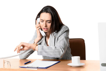Stressed secretary talking by phone and looking at watch while sitting at table on white background