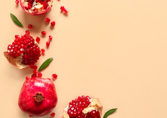 Tasty ripe pomegranate pieces on beige background