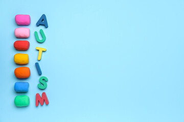 Word AUTISM with plasticine on blue background