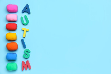 Word AUTISM with plasticine on blue background