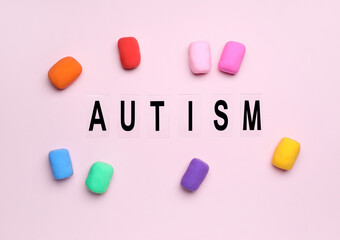 Word AUTISM with plasticine on pink background