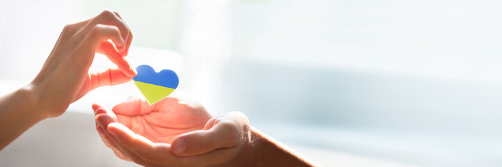 Woman Giving Heart On Man's Hand