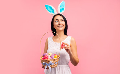 beautiful woman in rabbit ears with a basket of Easter eggs, on the Easter holiday