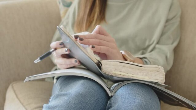 A girl picks up Bible and opens it.