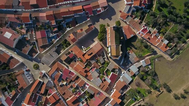 Aerial view of Elvas cityscape with brownish tiled roofs white buildings in sunny day, Portugal summer. Top view.