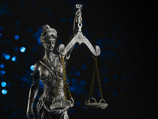 The goddess of justice - Themis on a dark blue background. Law, justice, judicial system, rule of law, advocacy, equality of law. There are no people in the photo.