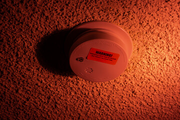 Orange fire alarm button. Isolated on an orange background. There are no people in the photo. There...
