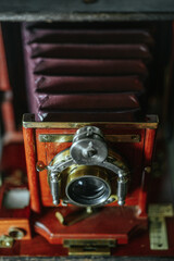 Beautiful antique large format Primo A camera with warm wooden frame, brass lens, exposure dials, and leather bellows