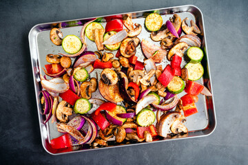 Overhead View of Raw Vegetables Seasoned with Olive Oil and Spices: Sliced and seasoned mushrooms,...