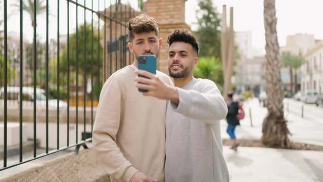 Young couple smiling confident make selfie by the smartphone at street